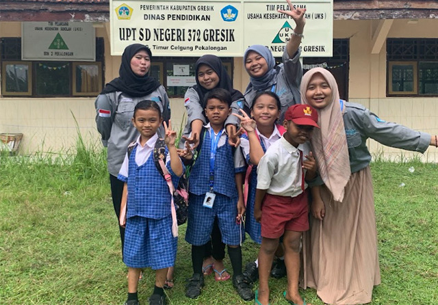 Caption:Sejumlah mahasiswa saat menjadi tenaga pendidik berfoto bersama beberapa murid UPT SDN 372 Gresik berlokasi di Pekalongan, Kecamaran Tambak, Bawean.