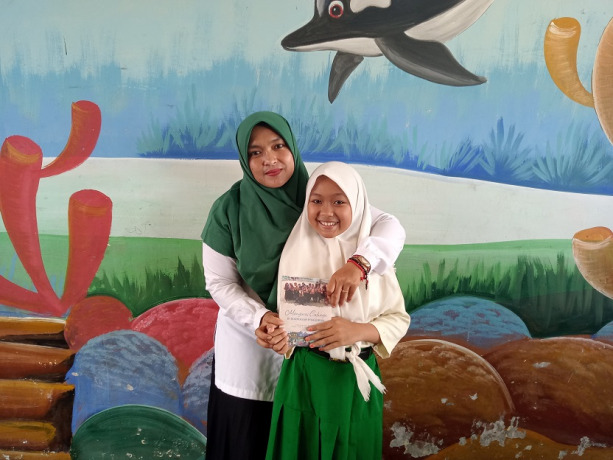 BERPRESTASI: Anindya Rizqy Maulana, siswa MI Darussalam 02 Jambearum, Kecamatan Puger, dipeluk Kepala MI Fatima Zahro setelah meraih prestasi di tingkat Jatim.
