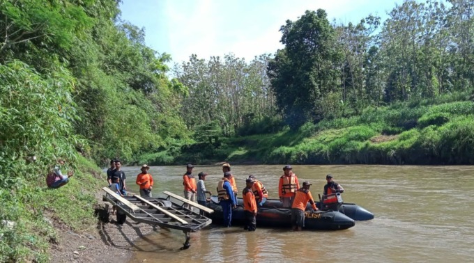 AKHIRNYA DITEMUKAN: Tim SAR gabungan bersama warga saat mengevakuasi jasad pelajar asal Wuluhan di sungai sekitar jembatan gantung Desa Sabrang, Ambulu.