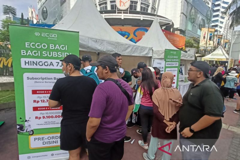 Pengunjung car free day (CFD) mengantri untuk melakukan pra pemesanan sepeda motor listrik ECGO di kawasan Sudirman, Jakarta, Minggu (5/2/2023)