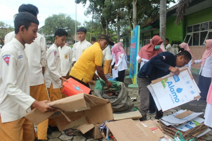SEDEKAH SAMPAH: Siswa SMPN 1 Balung membawa dan menyerahkan sampah dari rumah dan dananya dipakai untuk membangun musala. Foto: JUMAI/RADAR JEMBER
