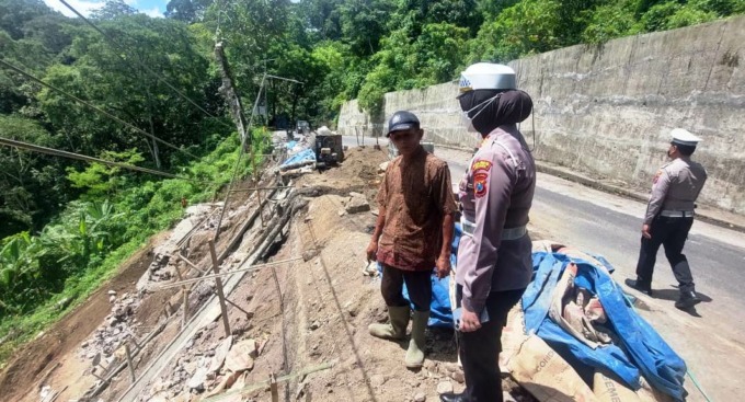 TINJAU LOKASI: Kasatlantas Polres Jember AKP Arum Inambala saat melihat langsung pengerjaan plengsengan penahan tebing di jalur Gumitir, Desa Sidomulyo, Silo, Jember, Sabtu (8/4). (FOTO: Jumai/Radar Jember)