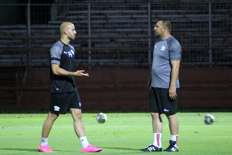 Pemain Timnas Palestina Mohammed Rashid berbincang dengan salah seorang tim pelatih saat latihan perdana di Stadion Gelora 10 November Surabaya, Minggu (11/6/2023) malam.