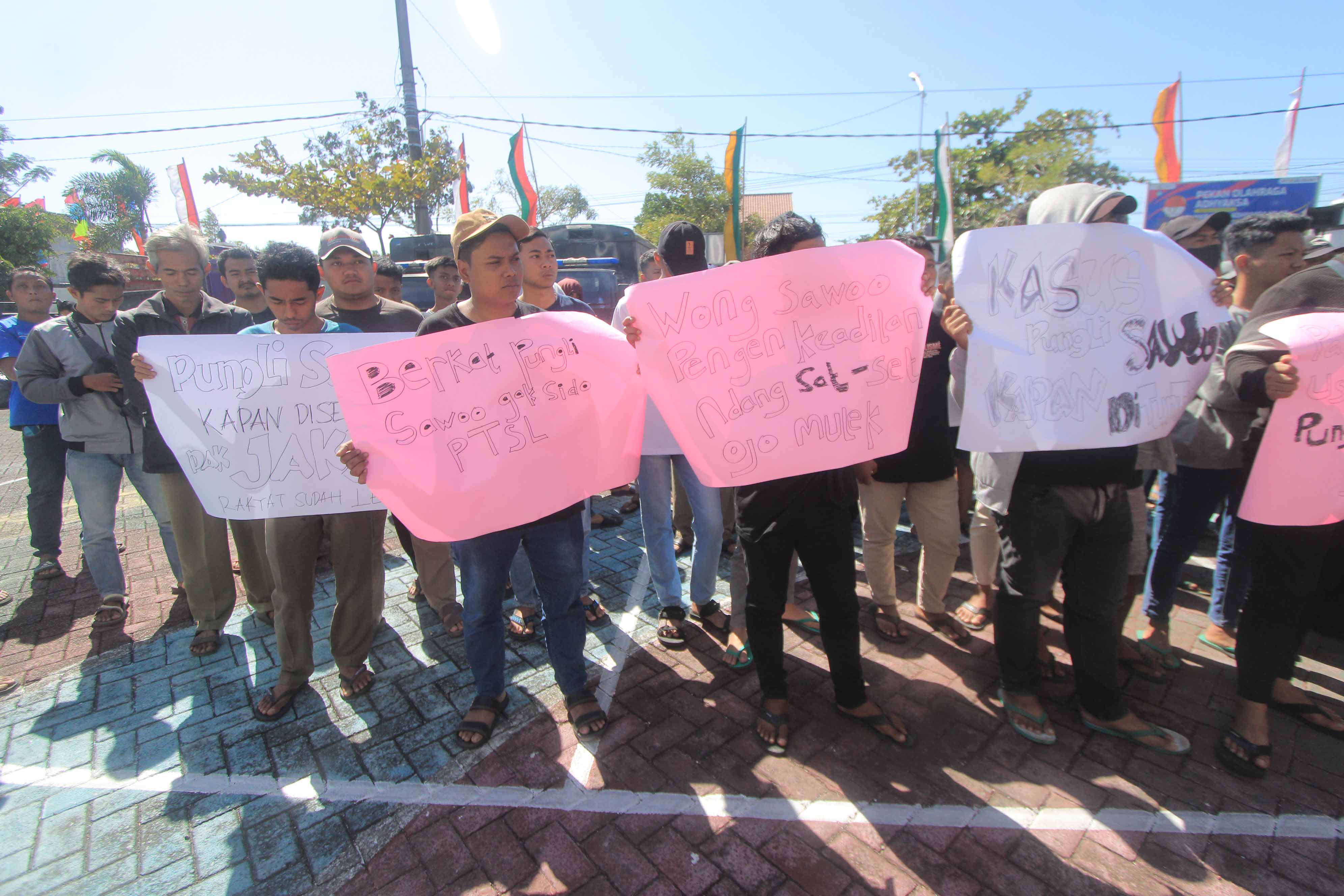 DEMONSTRASI: Ratusan warga Desa/Kec. Sawoo berunjuk rasa di Kantor Kejari Ponorogo menuntut kejelasan penanganan perkara dugaan pungli surat segel tanah kemarin (20/7).&nbsp;(AJI PUTRA/RADAR PONOROGO)