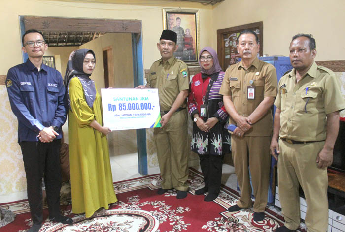 TERLINDUNGI: Pj Bupati Magetan Hergunadi (tiga dari kiri) dan Kepala BPJS Ketenagakerjaan Madiun Zakiah (tiga dari kanan) menyerahkan santunan kepada ahli waris Novan Triwardana.