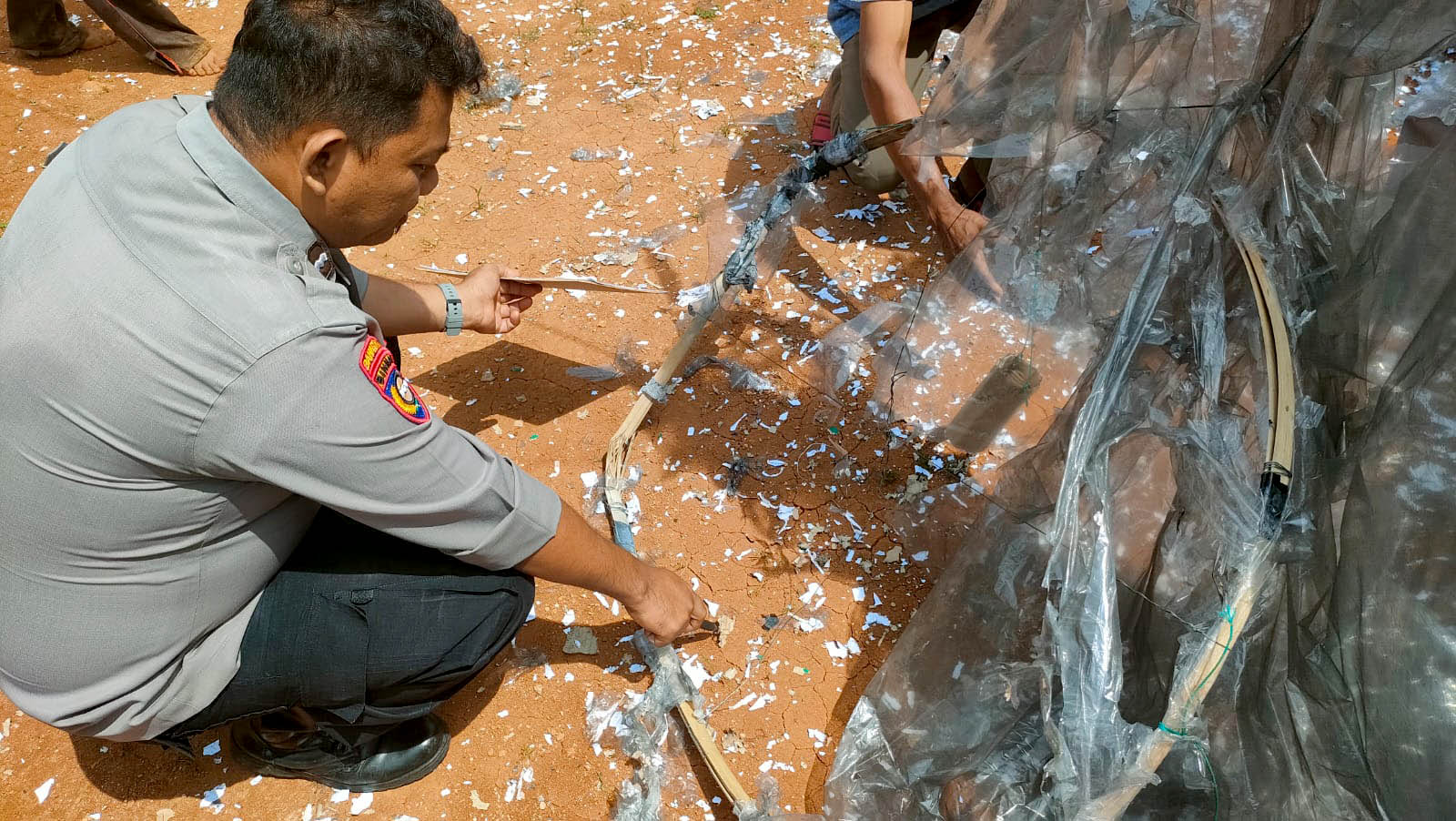 BELUM JELAS: Petugas Polsek Tegalombo melakukan olah TKP balon udara jatuh yang melukai empat warga.&nbsp;(NUR CAHYONO/RADAR PACITAN)