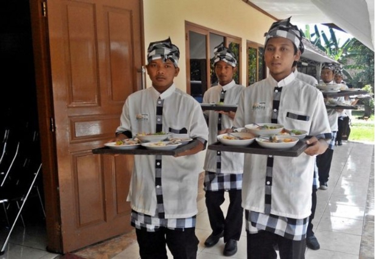 SUGUH: Para sinoman sing ngladeni para tamu ing pesta pernikahan adat Jawa. (SURAKARTA.GO.ID)