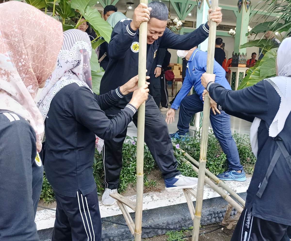 RAME: Para ASN Pemkab Madiun melu lomba balap egrang wingi (12/7). (LODITYA FERNANDEZ/RADAR MADIUN)