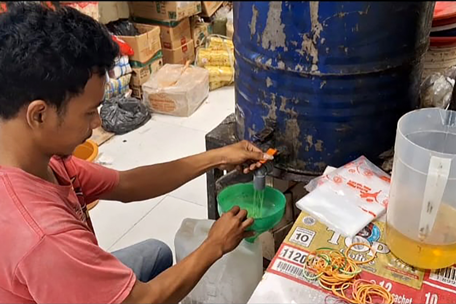 CARI YANG MURAH: Naiknya harga MinyaKita membuat sebagian warga beralih membeli minyak goreng curah.
