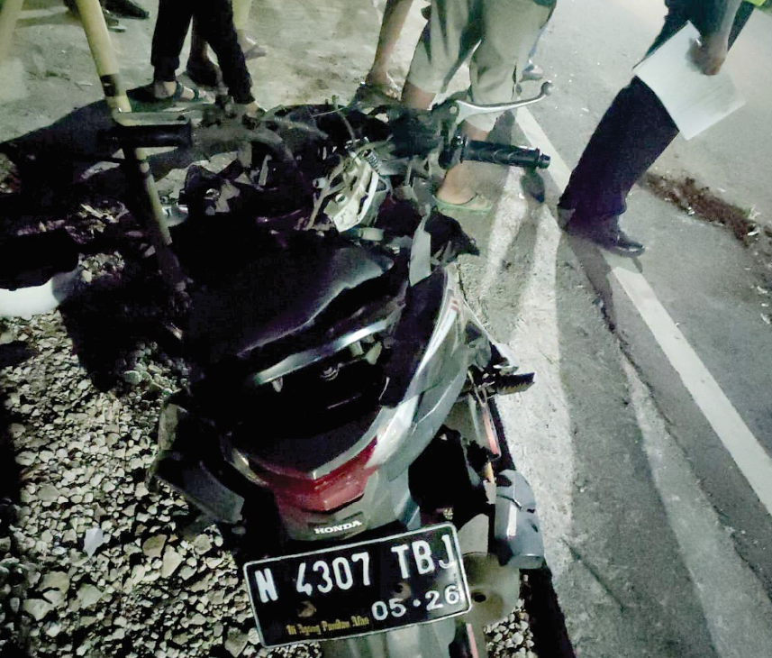 RINGSEK: Motor korban ringsek seusai menubruk bagian belakang truk di Jalan Raya Madiun-Dungus, Karangrejo, Wungu, Sabtu (10/8) malam. (SATLANTAS POLRES MADIUN)