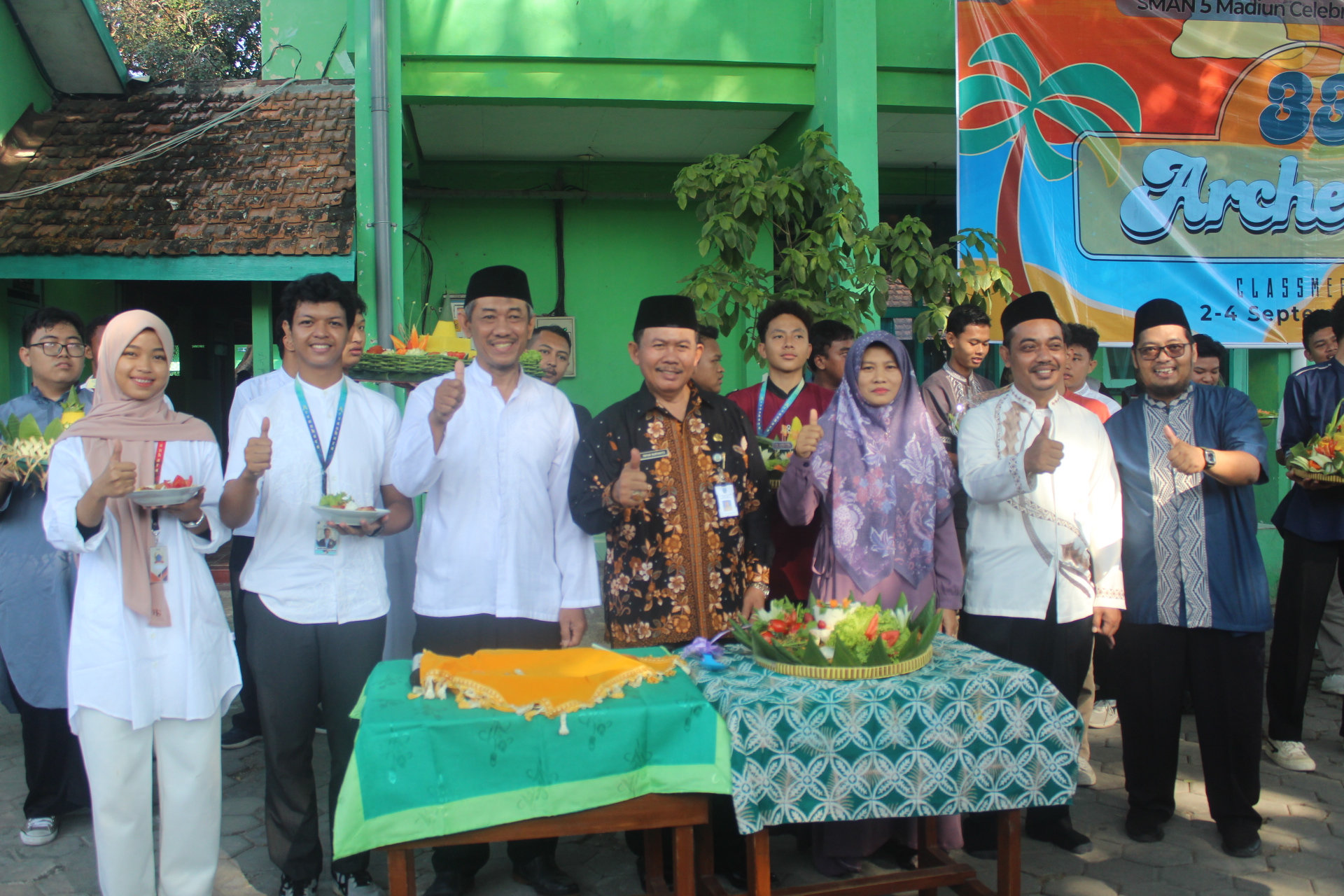 SEREMONI: Plt Kepala SMAN 5 Madiun Yayuk Nuryanto saat merayakan parade tumpeng bersama para guru dan siswa. (ABRIANTO WIBOWO/RADAR MADIUN)