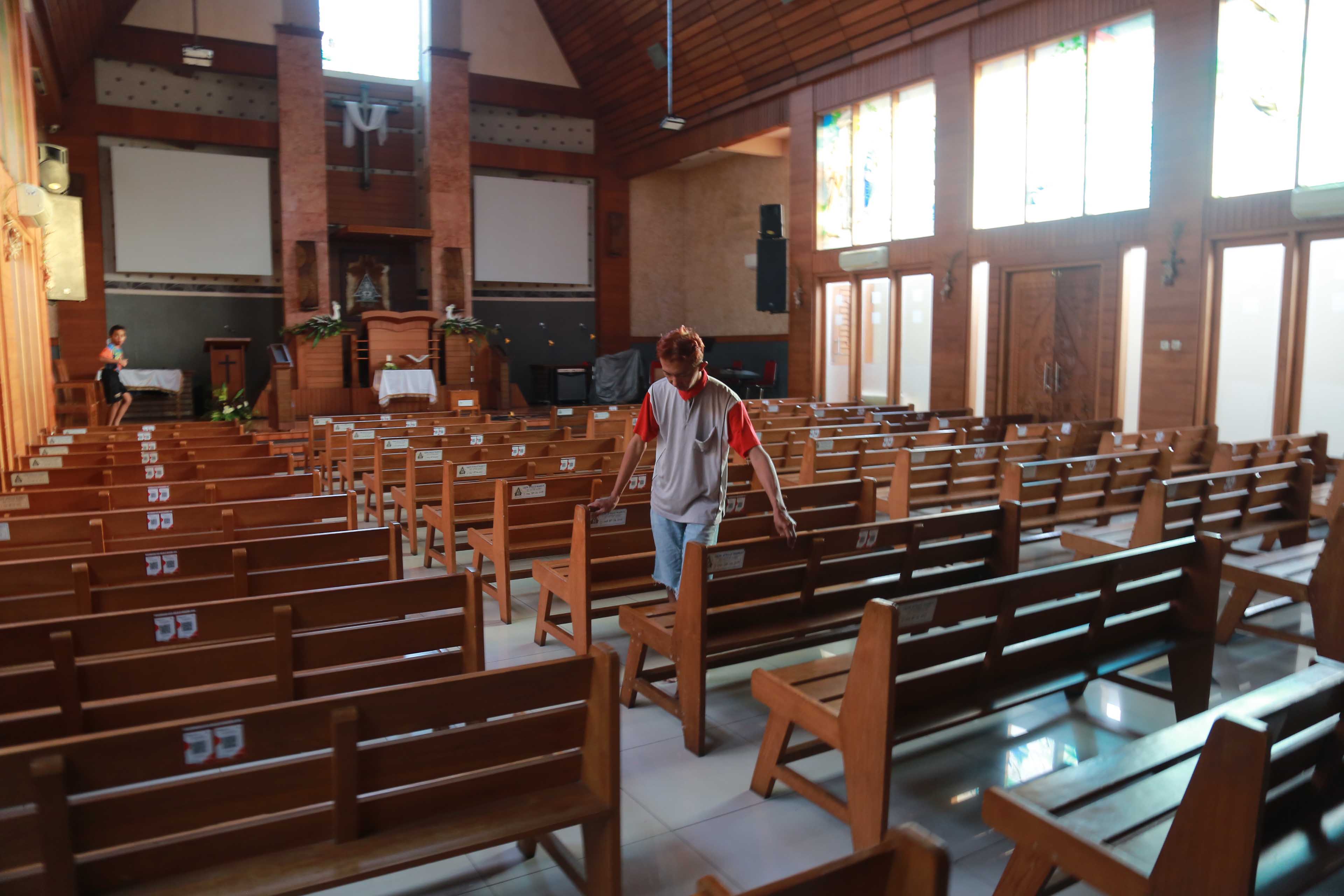 BERSIH-BERSIH: Seorang jemaat GKJW Kota Madiun sedang membersihkan gereja, Selasa 27 Mei 2025.