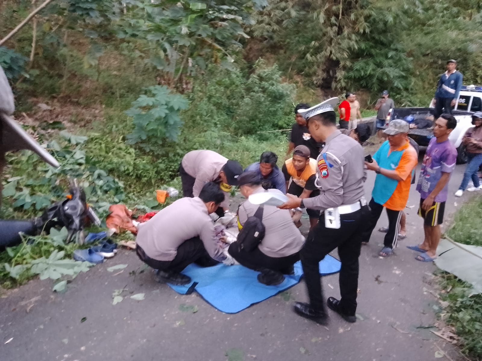 Petugas Satlantas Polres Pacitan mengevakuasi jasad korban kecelakaan motor di jalur Karanggede&ndash;Tokawi, Minggu (20/7). DOK RADAR PACITAN
