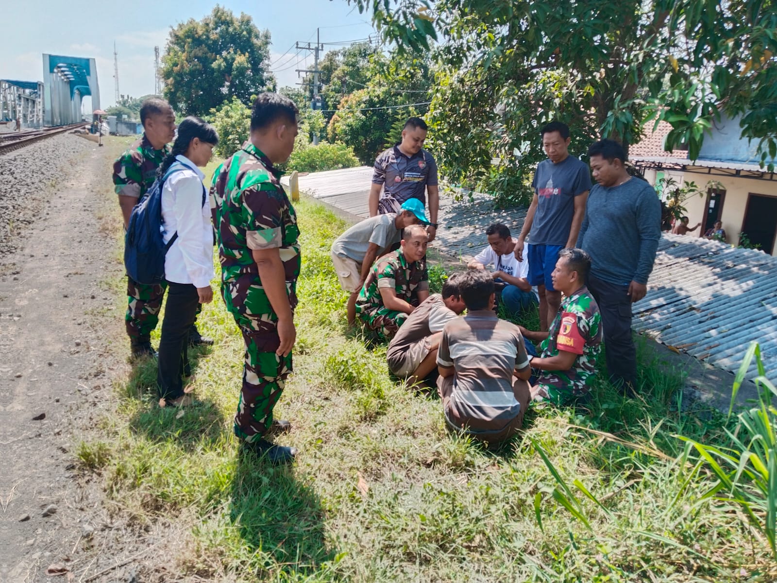 Anggota Koramil Manguharjo menyelamatkan mahasiswa ITS asal Madiun yang diduga depresi setelah sidang skripsi dan nekat berlari ke rel kereta api. FOTO: KORAMIL MANGUHARJO