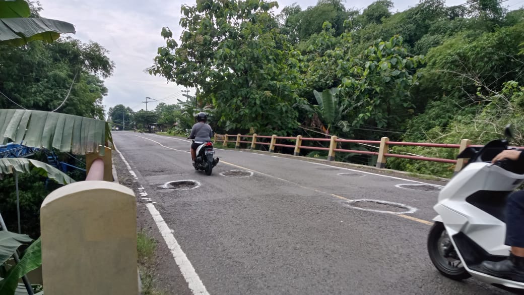 Lubang di Jembatan Bangon, Jalan Ngawi&ndash;Caruban, menjadi ancaman bagi pengendara. Beberapa pengguna jalan dilaporkan terperosok saat melintas. ASEP SYAEFUL/RADAR NGAWI