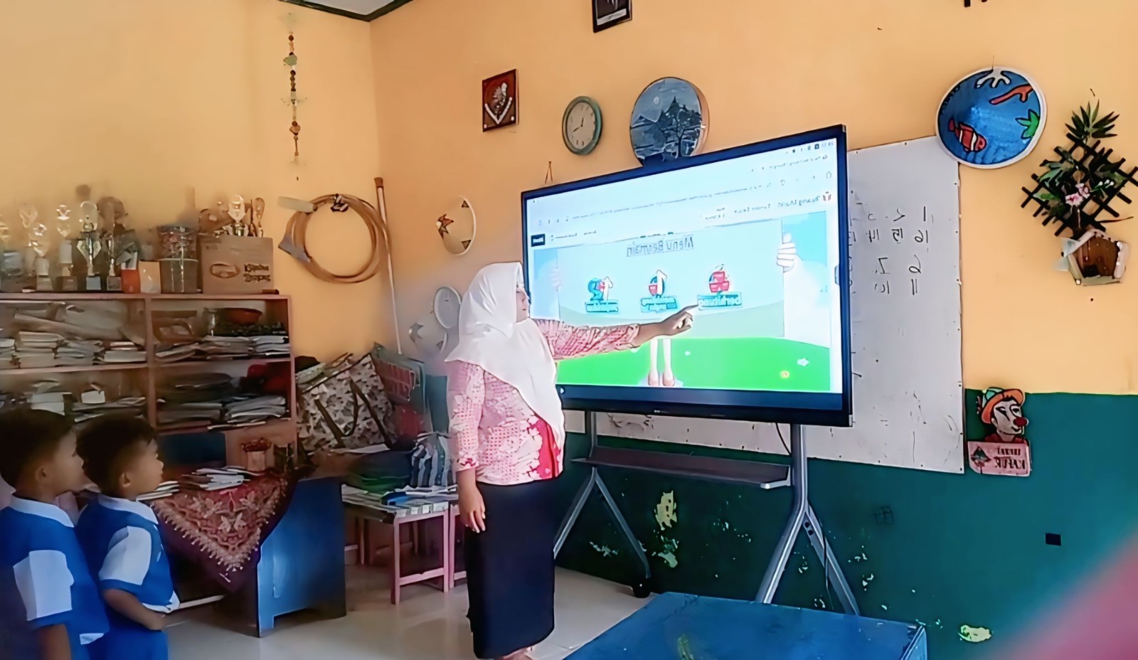 Seorang pengajar di Pacitan menggunakan smartboard sebagai media belajar. Distribusi perangkat IFP di daerah tersebut masih berlangsung dan belum merata. FOTO: ISTIMEWA