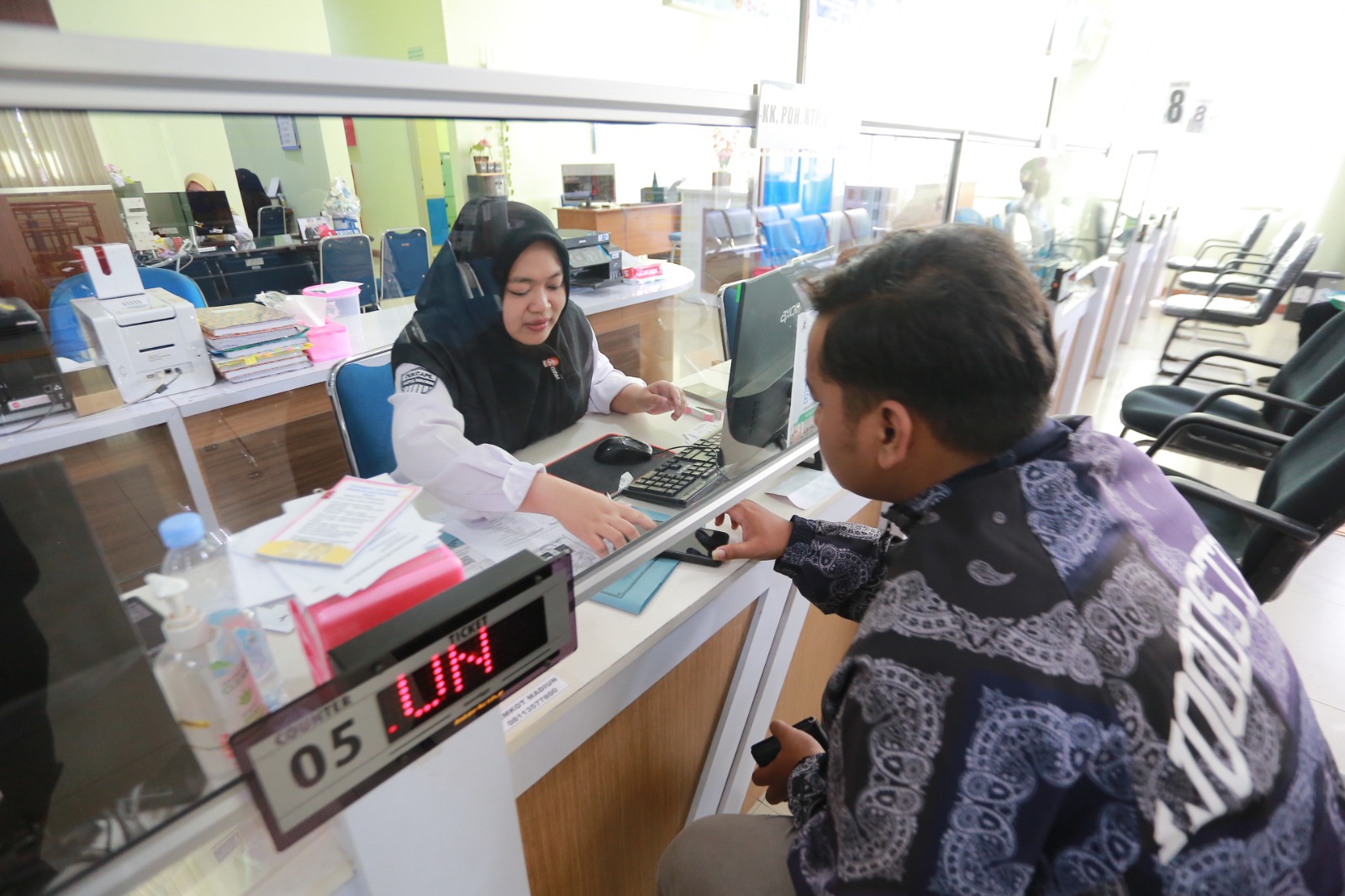 LAYANAN TETAP BUKA: Warga mengurus administrasi kependudukan di Dispendukcapil Kota Madiun yang tetap beroperasi selama libur Natal dan Tahun Baru. BAGAS BIMANTARA/RADAR MADIUN