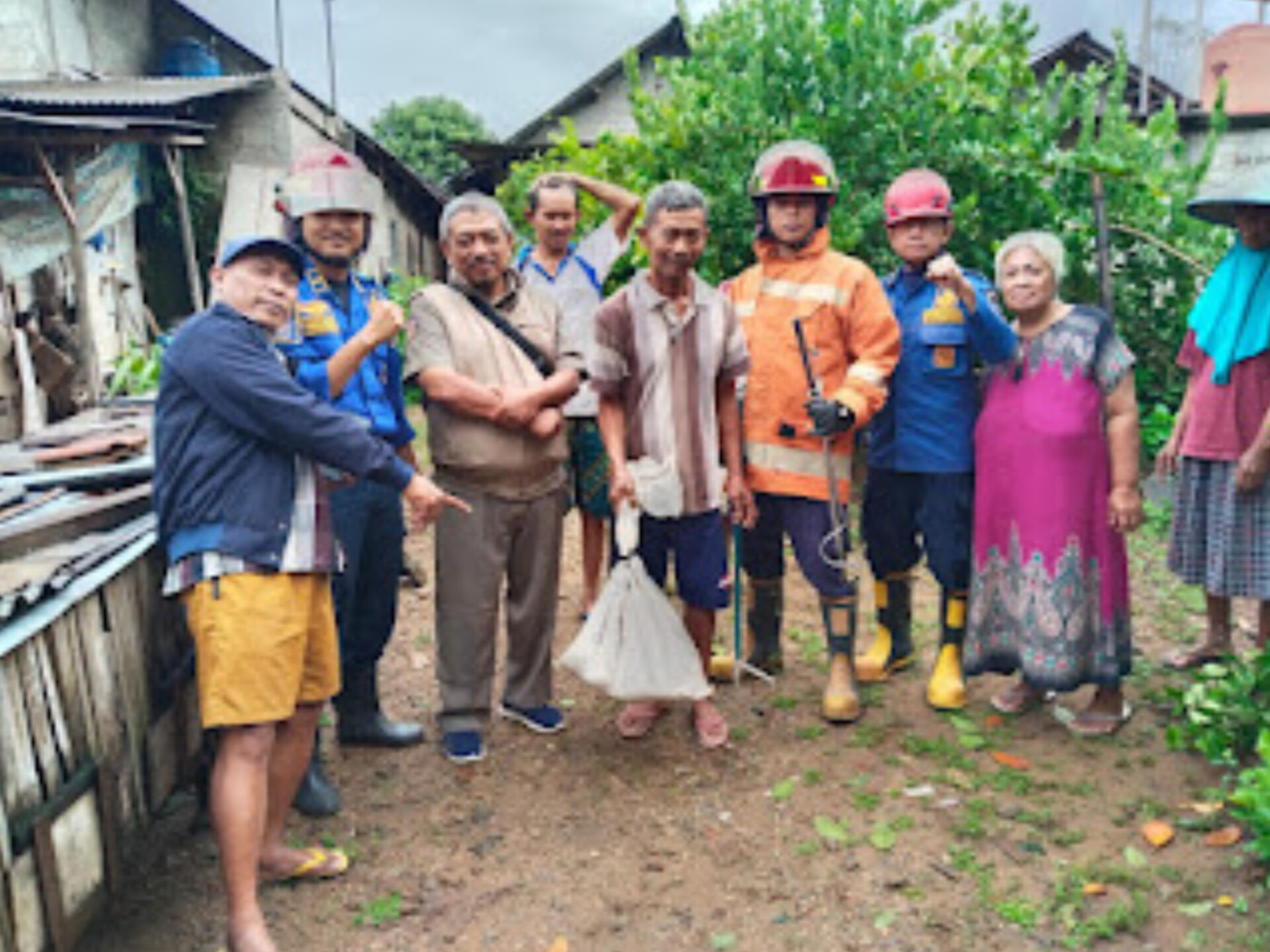 SENANG: Warga Lingkungan Plelen, Kelurahan Sidoharjo, Pacitan, berfoto bersama petugas usai evakuasi ular piton sepanjang 1,3 meter, kemarin (15/1).