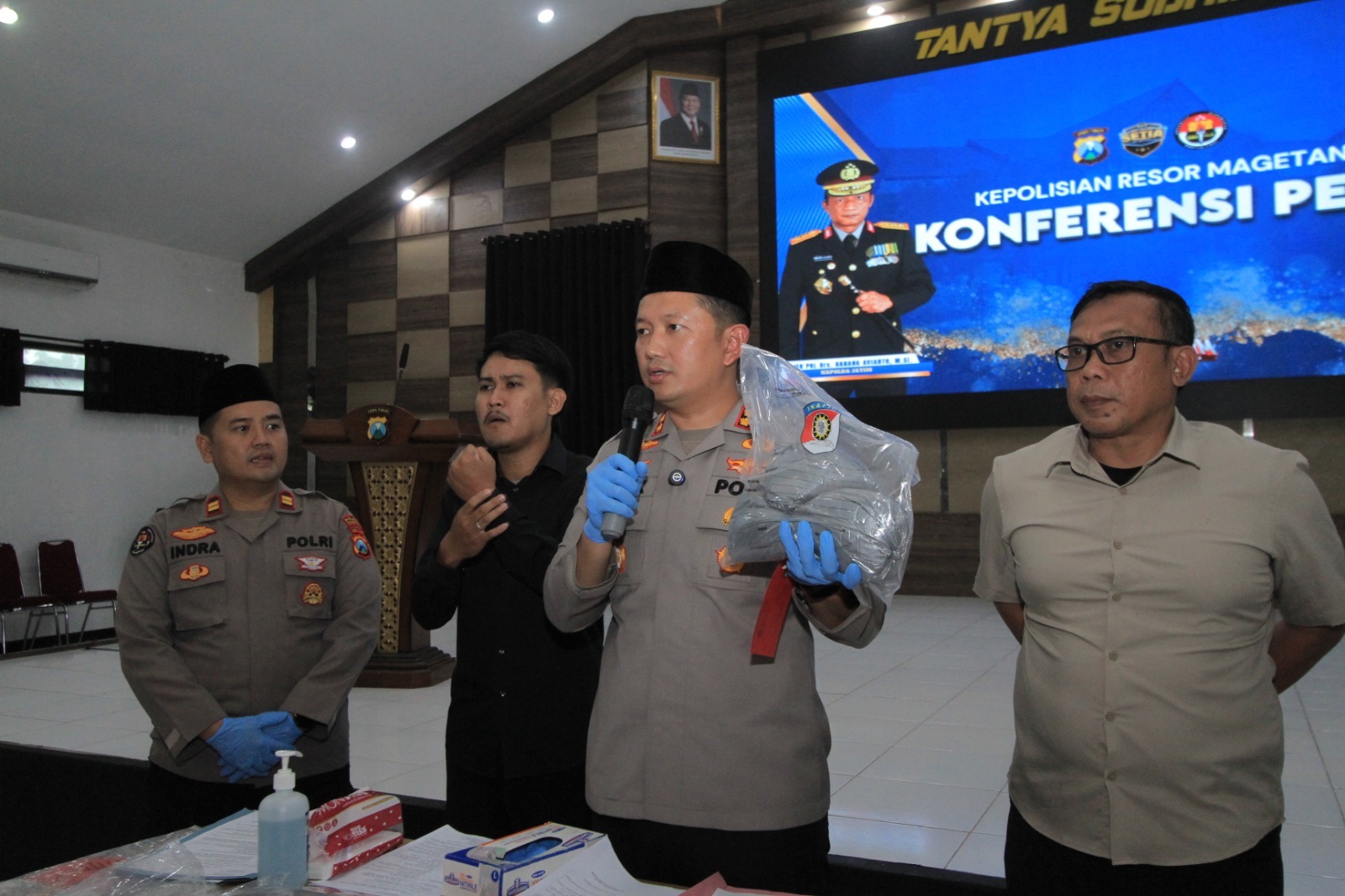 BARANG BUKTI: Kapolres Magetan AKBP Raden Erik Bangun Prakasa menunjukkan bubuk mesiu seberat tiga kilogram yang diamankan dari tersangka asal Kabupaten Madiun.