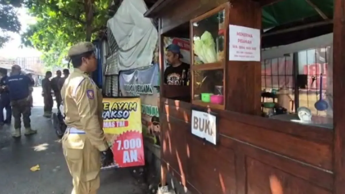 Petugas Satpol PP dan Damkar Ponorogo mengimbau PKL agar tidak meninggalkan lapak di kawasan Jalan Siberut, kemarin (6/5). SUGENG DWI N/JAWA POS RADAR PONOROGO
