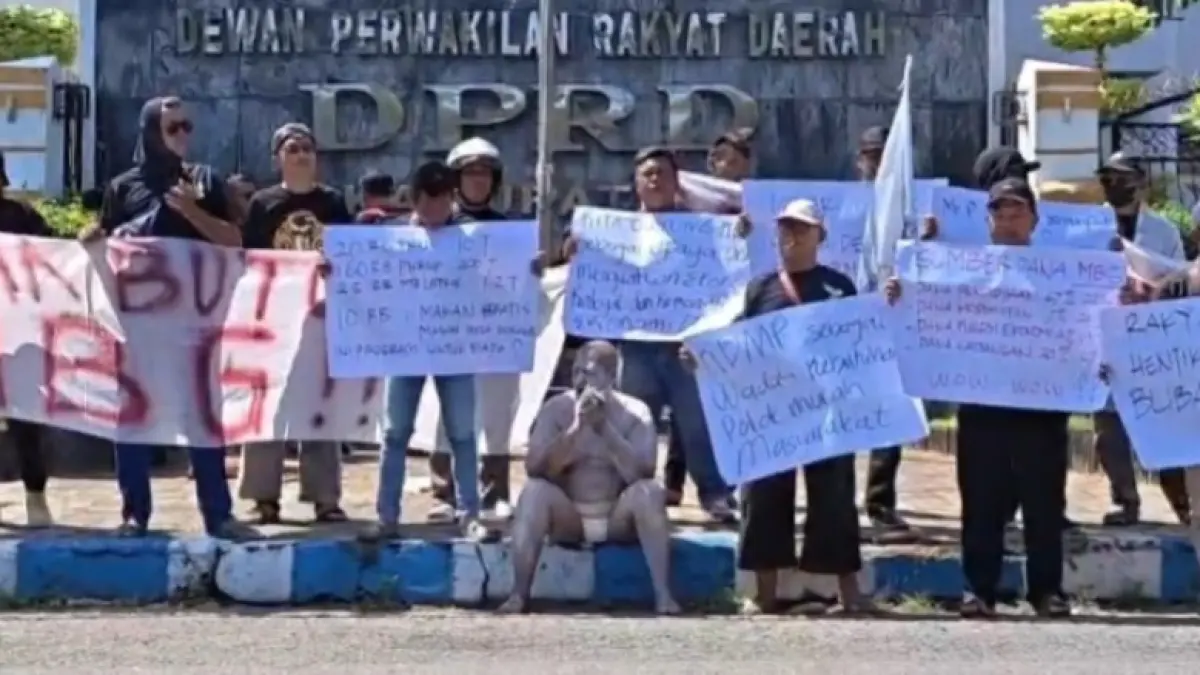 Massa Konsorsium Ponorogo Bersatu membentangkan spanduk penolakan program MBG saat aksi damai di depan DPRD Ponorogo. SUGENG DWI N/JAWA POS RADAR PONOROGO