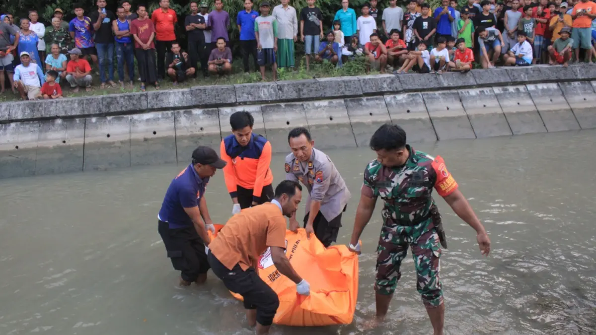 EVAKUASI KORBAN: Petugas kepolisian, BPBD, dan Tim Inafis mengevakuasi jasad Muhammad Mahfudin yang ditemukan mengapung di kanal irigasi Desa Jonggrang, Kecamatan Barat, Magetan, Rabu (10/6). AJI PUTRA/RADAR MAGETAN
