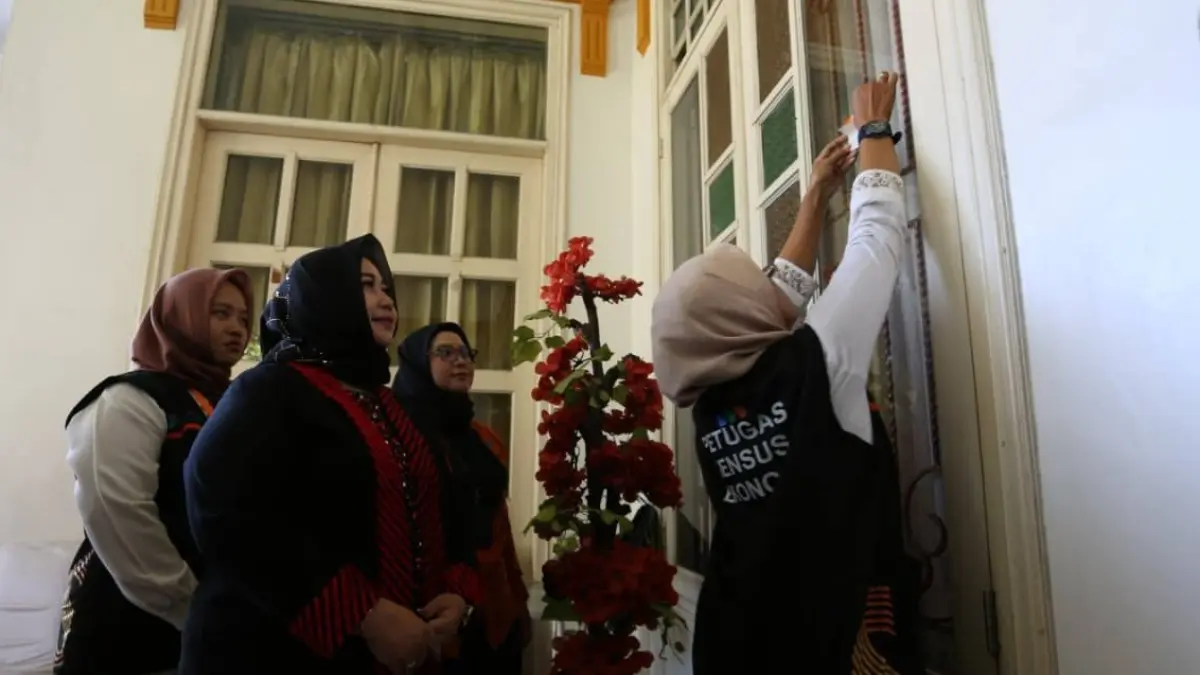 Petugas Sensus Ekonomi 2026 memasang stiker usai melakukan wawancara di rumah dinas Plt Bupati Ponorogo Lisdyarita. SUGENG DWI N/RADAR PONOROGO