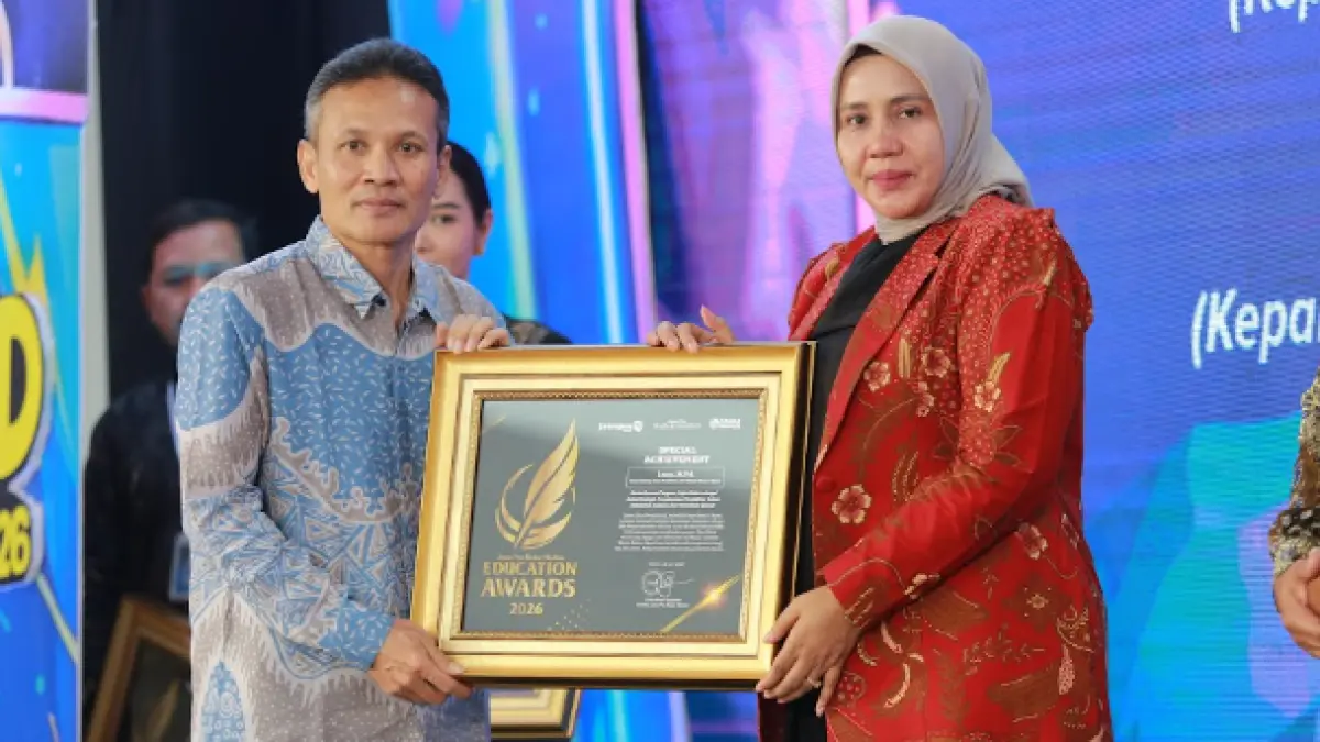 Direktur Jawa Pos Radar Marsudi Nurwahid menyerahkan penghargaan Special Achievement kepada Kadindik Kota Madiun Lismawati dalam ajang Radar Madiun Education Awards 2026, Minggu (28/6). (BAGAS BIMANTARA/RADAR MADIUN)