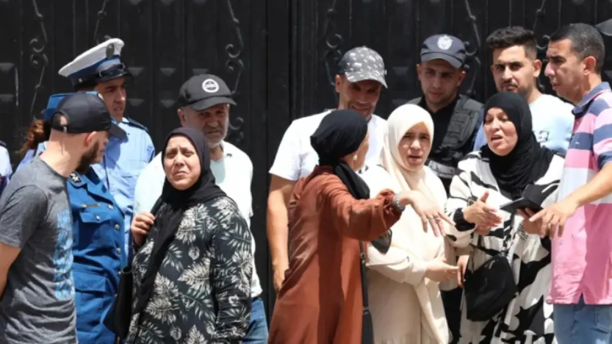 People gathered outside the orphanage after the fire, news of which has caused shock and outrage (BBC)