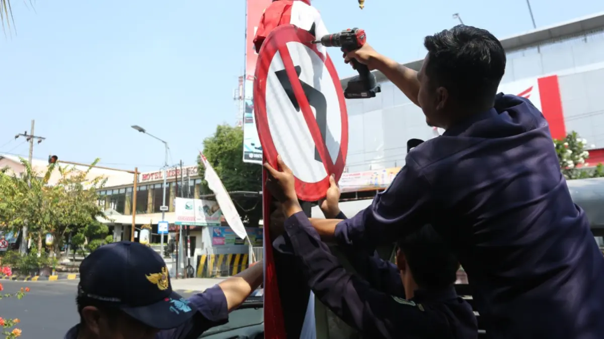 BERUBAH ARUS: Petugas Dishub Kota Madiun memasang penanda perubahan arus lalu lintas di Jalan Sulawesi dan Jalan Timor. BAGAS BIMANTARA/RADAR MADIUN