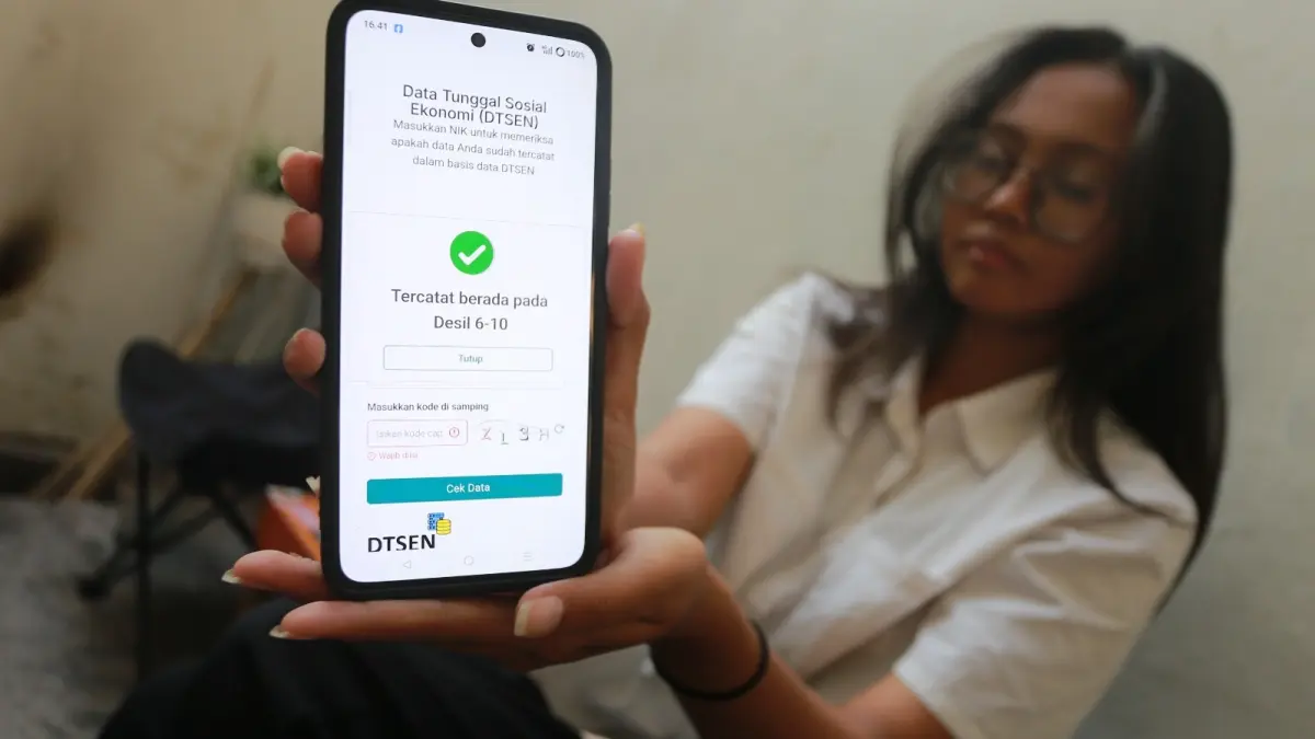 STATUS EKONOMI: Warga mengecek status desil melalui formulir DTSEN BPS, Rabu (19/8). ILUSTRASI FOTO: BAGAS BIMANTARA/JAWA POS RADAR MADIUN