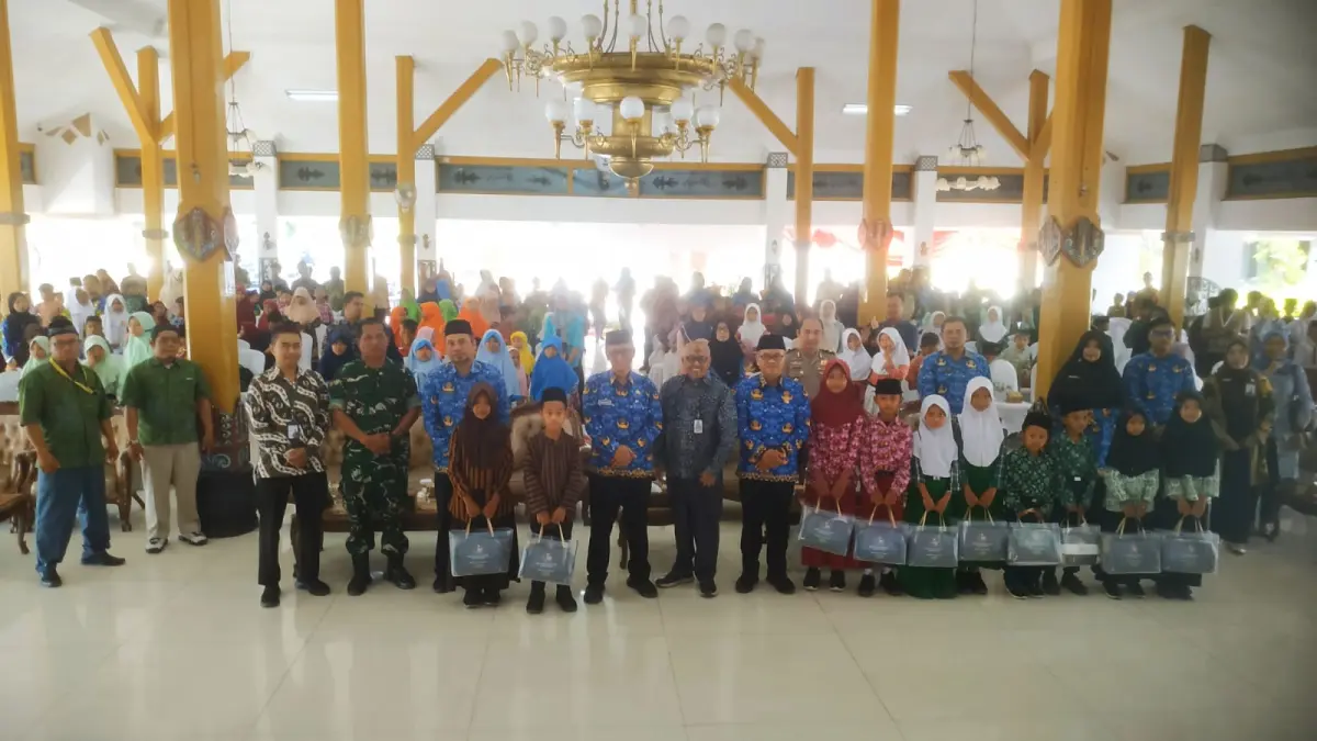 Jajaran BMT Bee Mass, bersama Pemda, perwakilan Forkopimda, DAN para donatur, berfoto bersama anak-anak sekolah pemerima santunan di Pendapa Wedya Graha Ngawi, Kamis (17/9).&nbsp;(SATRIO JATI WASKITO/RADAR MADIUN)