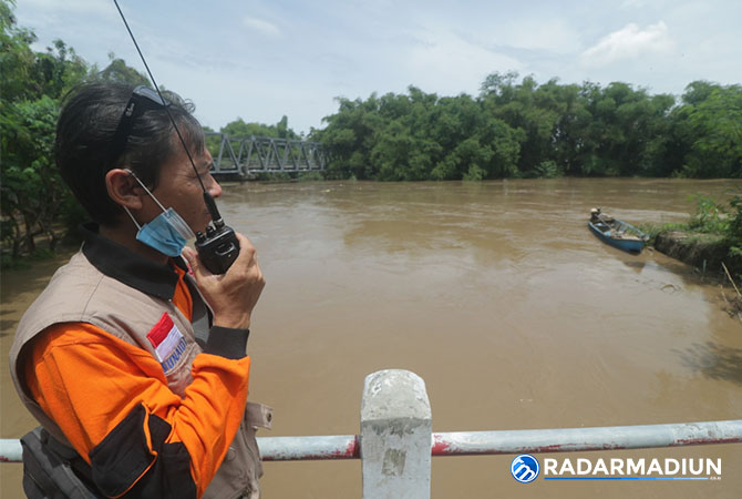 WASPADA BANJIR: Petugas BPBD Ngawi memantau debit Sungai Bengawan Solo. (R BAGUS RAHADI/RADAR NGAWI)