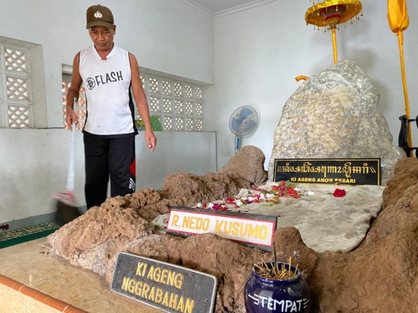 TELATEN: Kasmiadi sedang membersihkan kompleks makam Kuncen Caruban. (M.R. AKROMU NIAM/JAWA POS RADAR CARUBAN)
