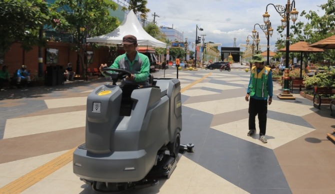 BERSIH-BERSIH: Petugas Disperkim Kota Madiun mulai mengoperasikan dua unit mesin polisher listrik di kawasan Sumber Wangi-Sumber Umis kemarin (26/10). (BAGAS BIMANTARA/JAWA POS RADAR MADIUN)