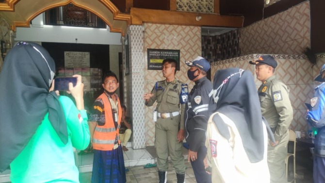 PERSUASIF: Petugas Satpol PP Kota Madiun menertibkan aktivitas penggalangan donasi pembangunan masjid di Klegen kemarin (21/10). (ISTIMEWA)