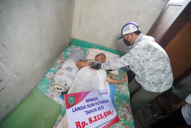 PERHATIAN KHUSUS: Wali Kota Madiun Maidi menyalurkan bansos lansia nonpotensial di Kecamatan Kartoharjo kemarin (31/10). (BAGAS BIMANTARA/JAWA POS RADAR MADIUN)