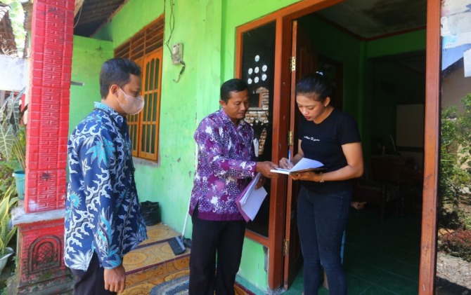 BUKAN COD: Salah serorang pemohon menerima berkas dari petugas Pecel Mas Kelurahan Manguharjo, Kamis (12/1). (BAGAS BIMANTARA/JAWA POS RADAR MADIUN)