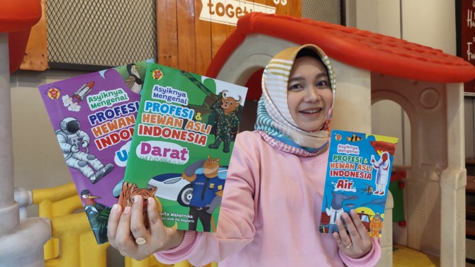 EDUKASI : Yuwita Wahernika menunjukkan beberapa buku anak karyanya. (DIAN RAHAYU/JAWA POS RADAR CARUBAN)