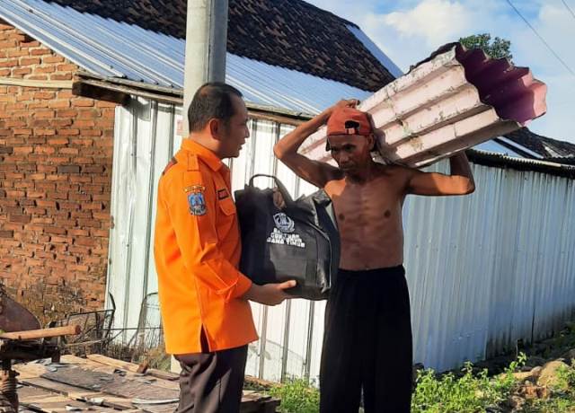 LOGISTIK: Relawan membagikan bantuan logistik untuk warga terdampak puting beliung di Kecamatan Wonoasri, Senin (6/3). (KECAMATAN WONOASRI UNTUK JAWA POS RADAR CARUBAN)