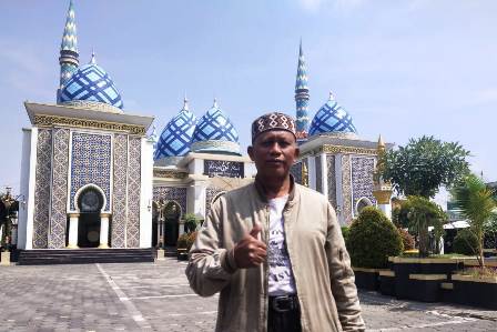 PENGABDIAN: Sumanto berpose di depan Masjid Agung Baitul Hakim. (RAHMA DWI LESTARI/JAWA POS RADAR MADIUN)