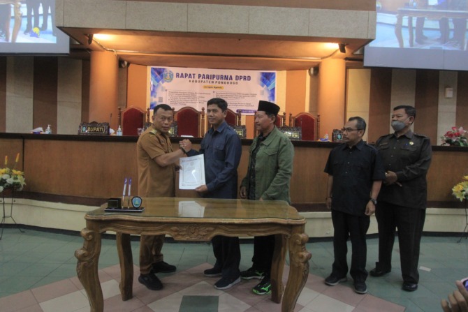 CATATAN WAKIL RAKYAT : Ketua DPRD Ponorogo Sunarto menyerahkan rekomendasi pansus LKPJ 2022 kepada Bupati Ponorogo Sugiri Sancoko usai rapat paripurna kemarin (15/5). (AJI PUTRA/JAWA POS RADAR PONOROGO)