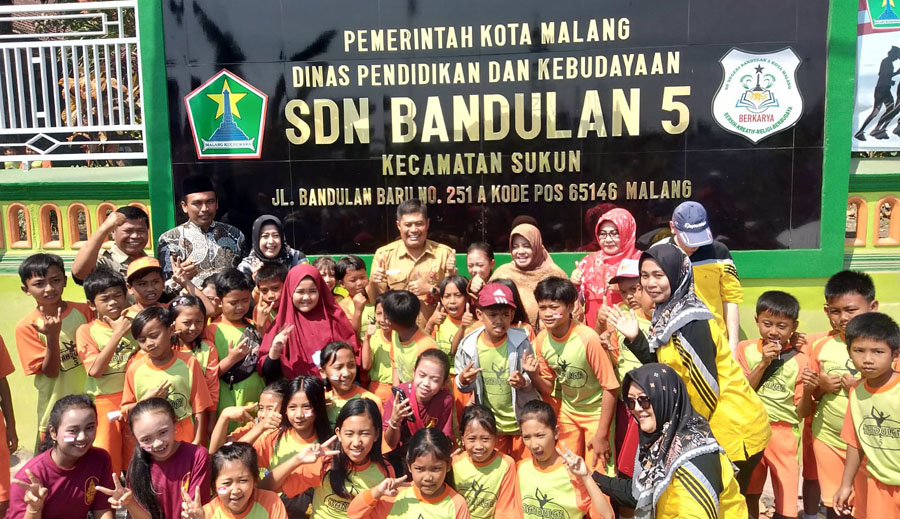 BERI APRESIASI : Kepala Disdikbud Kota Malang Suwarjana SE MM (tengah berdiri) bersama siswa, guru dan staf saat peresmian pagar sekolah SDN Bandulan 5 Malang, Selasa (29/08).