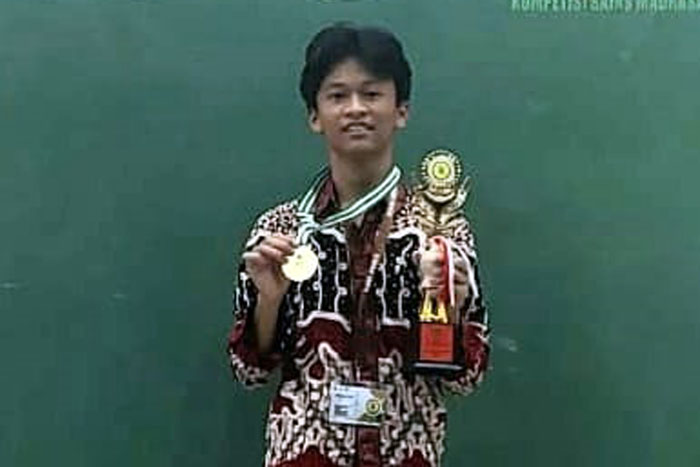 Muhammad Irsyad Asrif menerima medali emas dan piala juara pertama pada KSM Nasional.