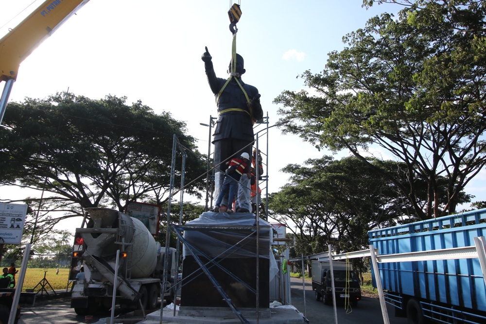 TERPASANG: Sejumlah pekerja melakukan tahapan finishing pada patung Bung Karno yang baru dipasang menggunakan alat berat di kawasan Jalibar kemarin. (Darmono/Radar Malang)  &nbsp;