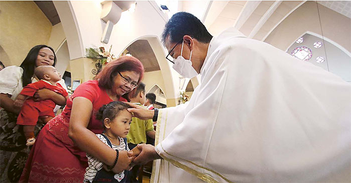 KHIDMAT: Anak-anak mengikuti prosesi pemberian berkat setelah misa di Gereja Katedral Paroki Santa Perawan Maria dari Gunung Karmel atau Gereja Ijen, kemarin (25/12).