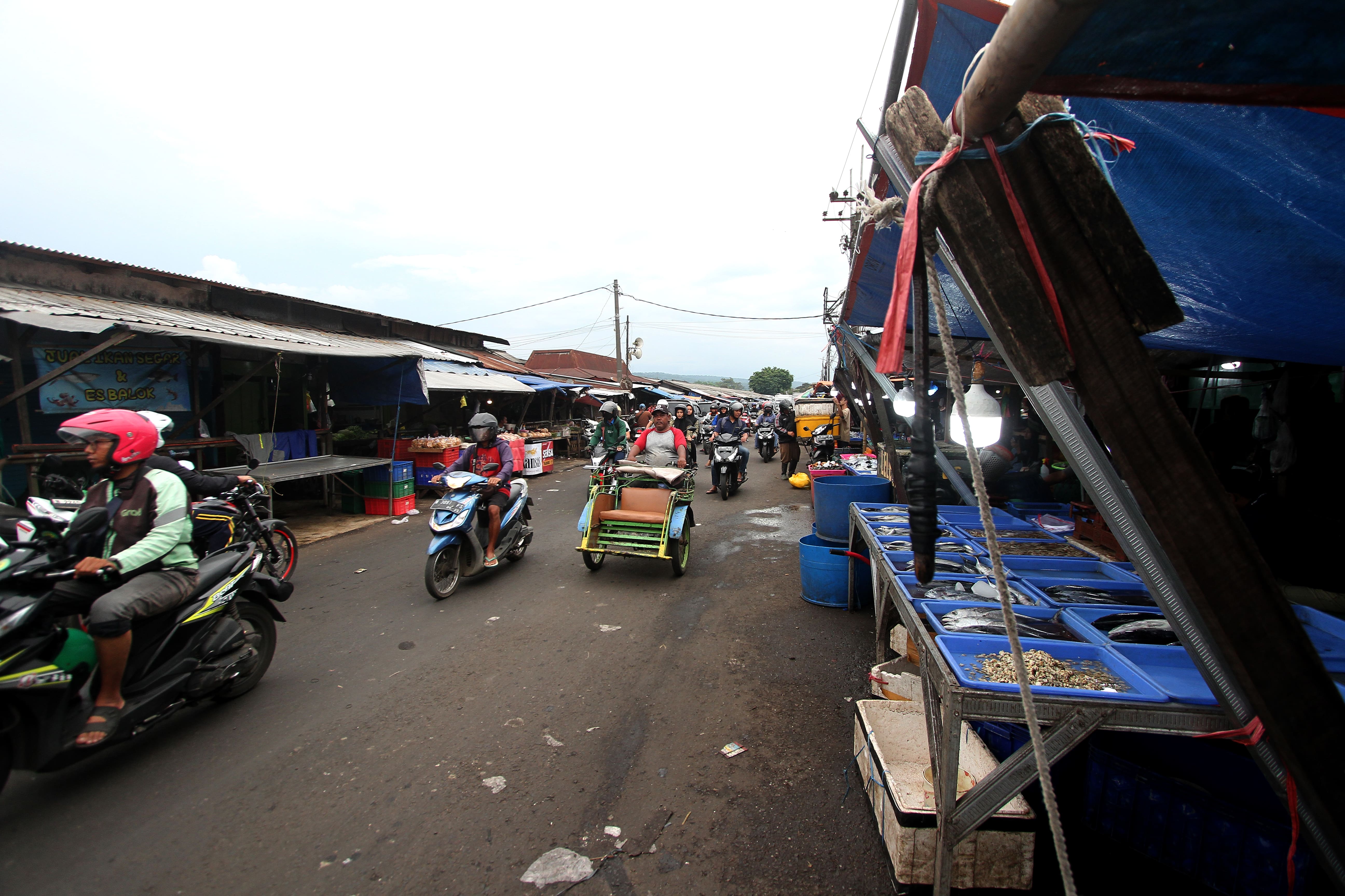 AKSES PEDAGANG: Ruas jalan di Pasar Gadang sebagian sudah mulus, tapi penambalan bersifat sementara. Pengerjaan permanen yang rencananya digarap tahun ini ternyata batal terealisasi.