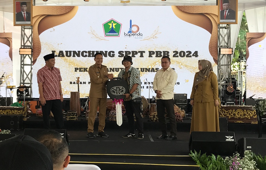 DAPAT HADIAH: Salah satu wajib pajak menjadi pemenang utama Gebyar Sadar Pajak tahap dua dengan membawa pulang mobil Toyota Calya. (Satria Cahyono/Radar Malang)