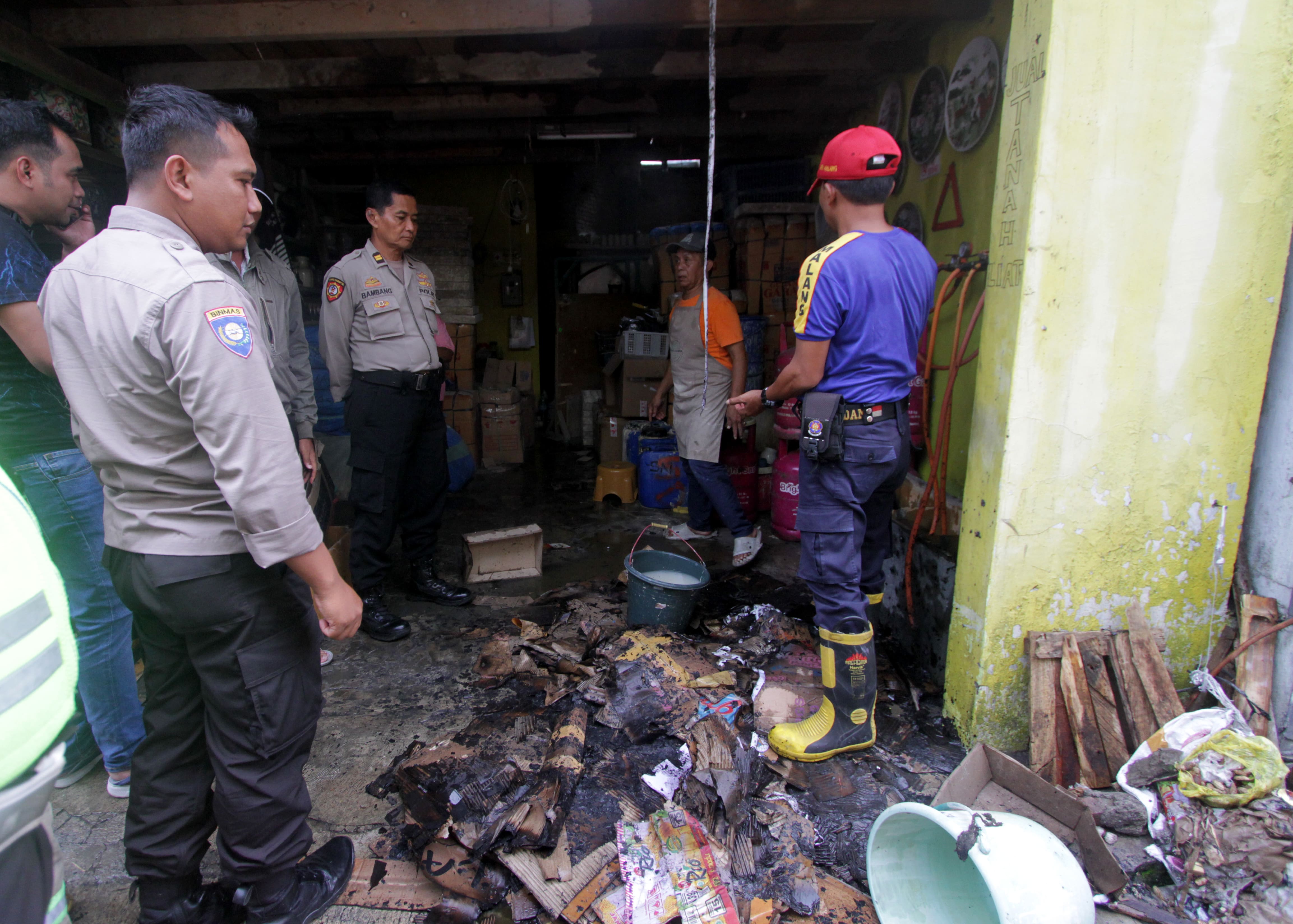 SIGAP: Personel Damkar Kota Malang bersama polisi setelah melakukan pemadaman di lokasi kebakaran kemarin.