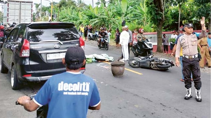 ISTRI MENINGGAL: Polisi turun ke lokasi kecelakaan di Jalan Raya Desa Pamotan, Kecamatan Dampit kemarin siang. Kecelakaan itu melibatkan tiga kendaraan.
